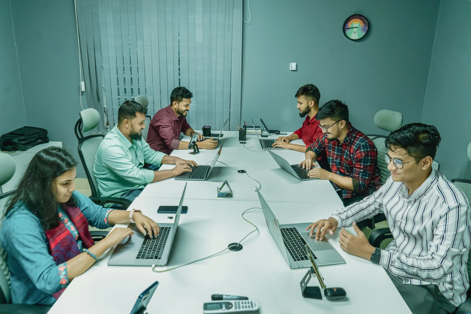 A professional team working together with laptops in an office