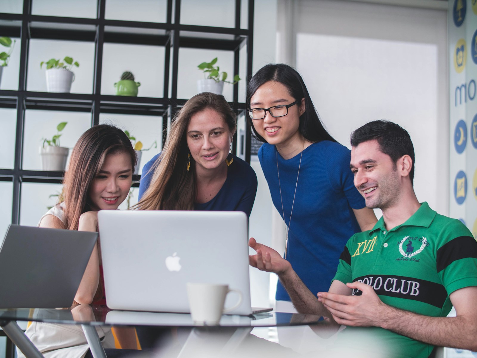 Colleagues discussing a business requirement around a laptop